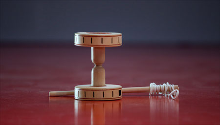 A traditional wooden Chinese yo-yo (diabolo) with handsticks